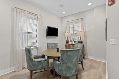 Well-furnished activity room with a round table and chairs