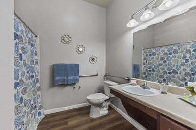 Clean bathroom with floral decorations and lighting