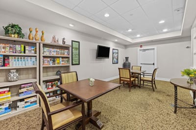 Bright common area with game tables and bookshelves