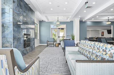 Bright interior common area with comfortable seating and fireplace