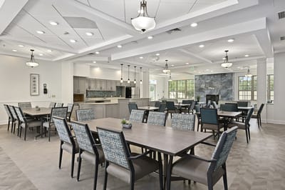 Bright dining room with tables and chairs set up