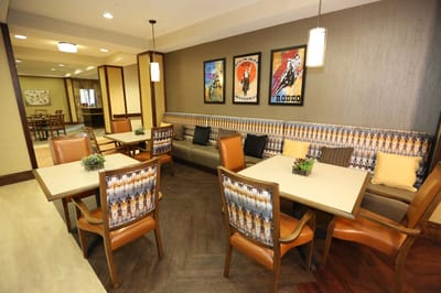 Dining area with tables and colorful artwork