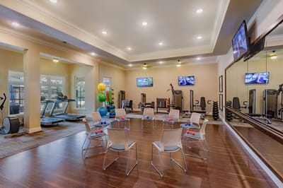 Interior view of a fitness area with equipment and seating