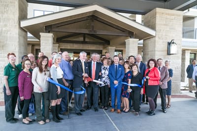 Ribbon-cutting ceremony with staff and community members