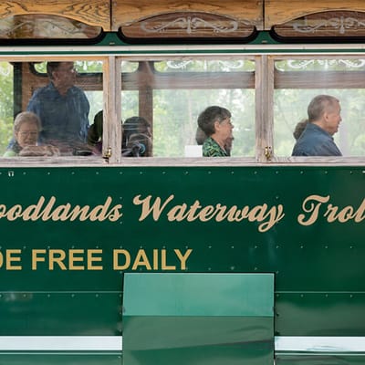 Residents riding on the Woodlands Waterway Trolley