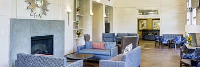 Bright common area with comfortable seating and a fireplace