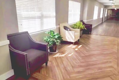 Corner of an interior hallway with seating and plants