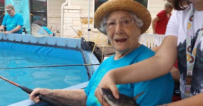 Resident enjoying fishing activity with a child