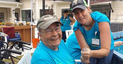 Residents enjoying an outdoor activity with staff