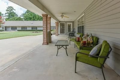Outdoor seating area with green chairs and tables