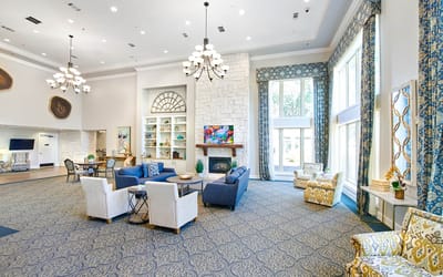 Bright common area with comfortable seating and large windows