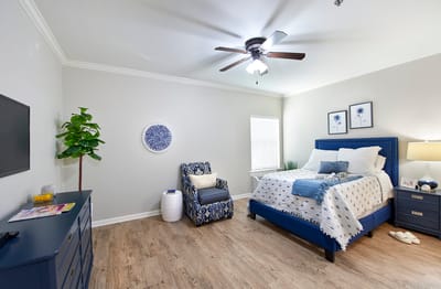 Cozy private resident room with a bed and chair