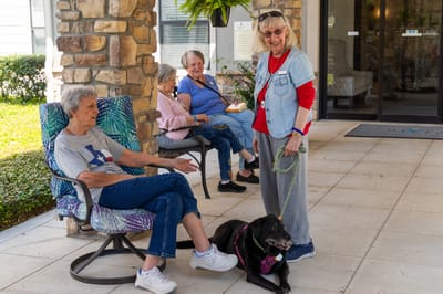 Residents enjoying time outdoors with a dog