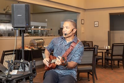 Musician performing for residents in a dining area