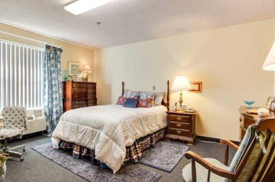 Cozy resident room with bed and furniture