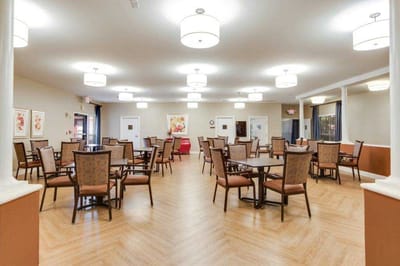 Bright dining room with tables and chairs set up
