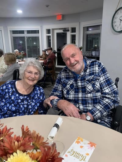 Two smiling residents enjoying time at a communal gathering
