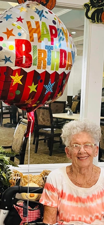 Resident celebrating with a birthday balloon