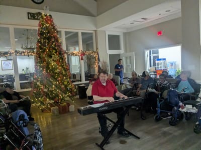Residents enjoying live music in a festive common area