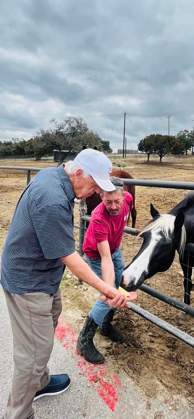 Residents interacting with a horse at a farm