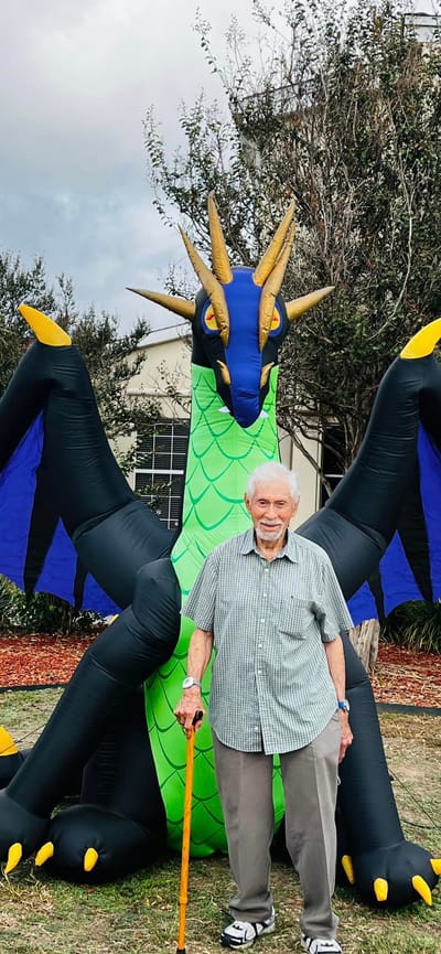 Resident posing with an inflatable dragon outside
