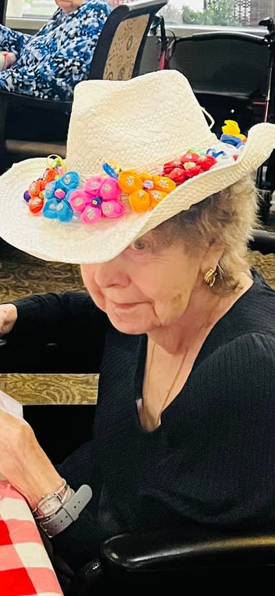 Resident wearing a decorated cowboy hat in a common area