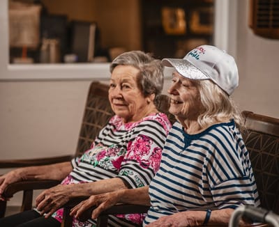 Two residents enjoying a moment together in a common area