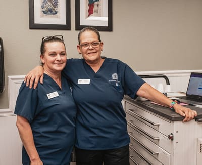 Two staff members posing together in the facility