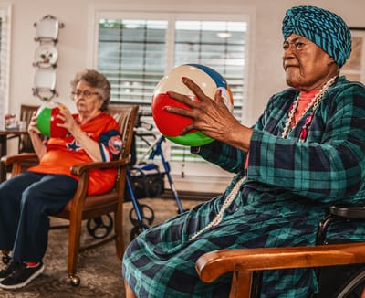 Residents engaging in a recreational activity with beach balls.