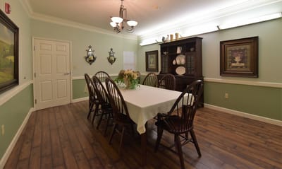 Dining room with a large table and wooden chairs