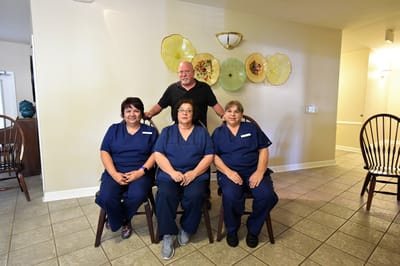 Staff members posing in a facility common area