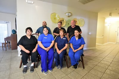 Staff members posing in a common area