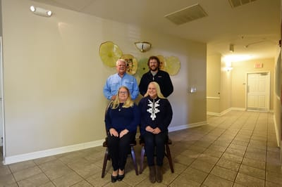 Staff members posing in a facility common area
