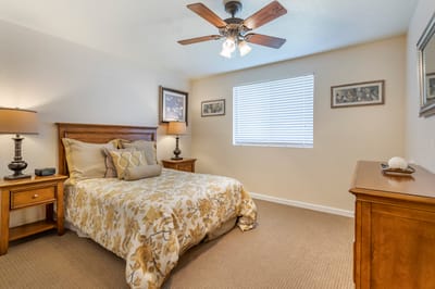 Cozy resident room with floral bedding and natural light