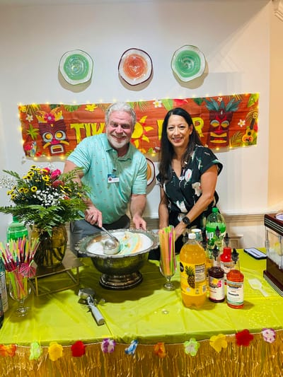 Staff serving refreshments at a festive event