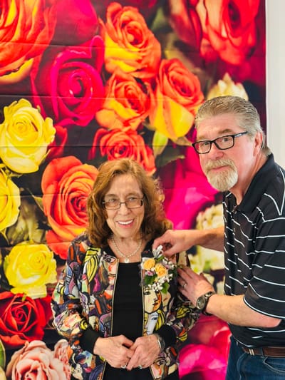 Residents enjoying a festive celebration with flowers backdrop