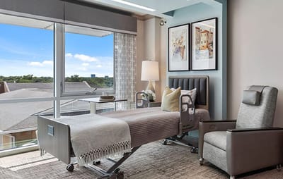 Comfortable patient room with a bed and a chair