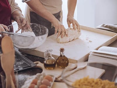 Two residents baking bread in a kitchen.