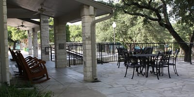 Patio area with seating and greenery