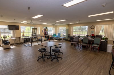 Interior view of an activity room with tables and equipment