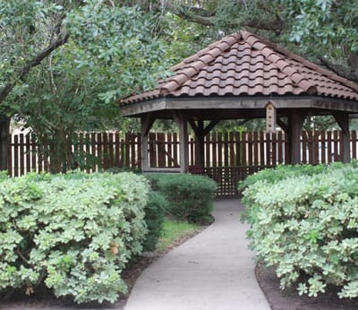 Gazebo surrounded by greenery in a peaceful garden