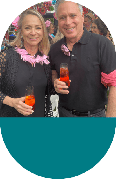 Two residents celebrating at a festive event with drinks.