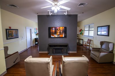 Bright common area with seating and a TV
