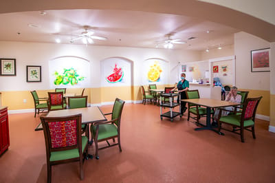 Bright interior dining area with residents and staff