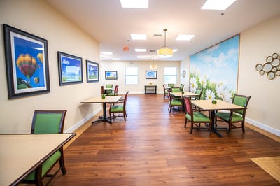 Dining area with tables and green chairs
