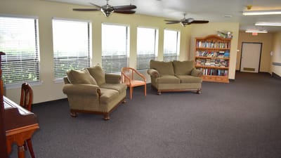 Bright common area with seating and bookshelves