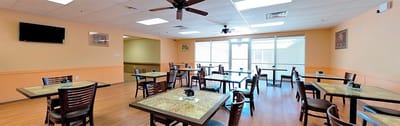Bright dining room with tables set for meals