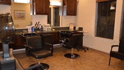 Interior view of a salon area with chairs and mirrors