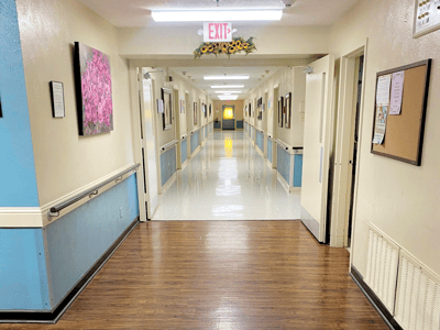 A brightly lit hallway in an assisted living facility