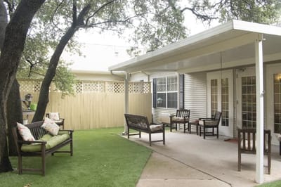 Outdoor seating area with green grass and benches